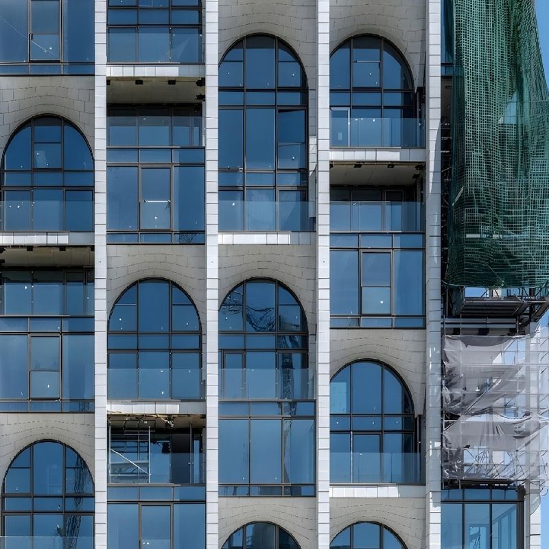 Close-up of the glass arches installed on the restored façade of Post Rotterdam